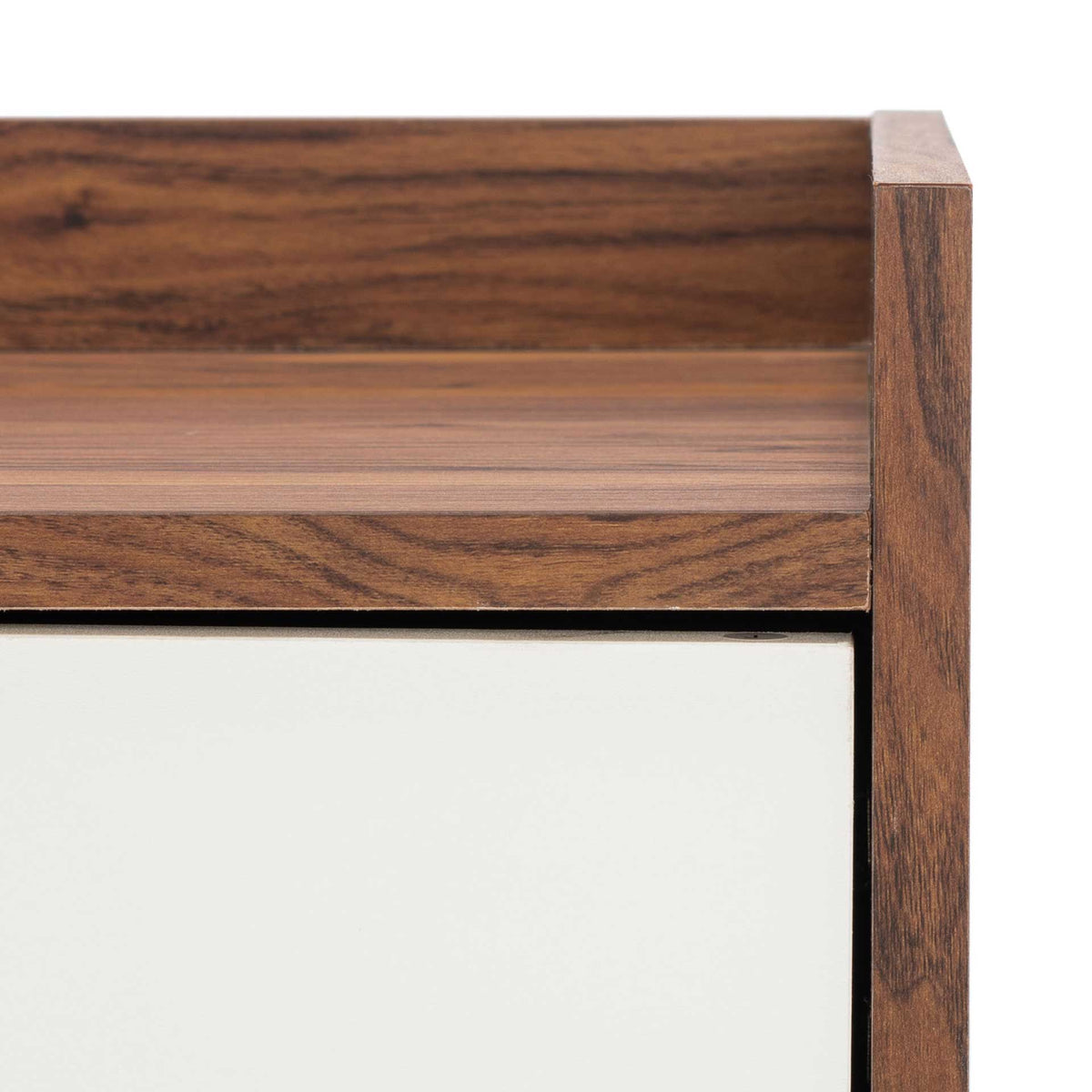 Warm wood-grain trim and a raised top edge frame the crisp white cabinet door