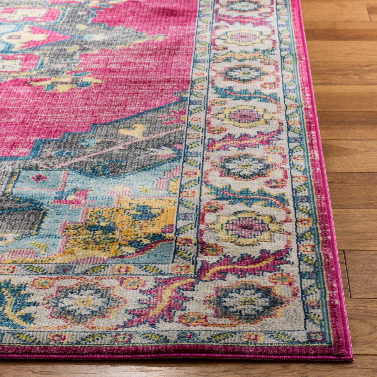 Bright floral border and pink bound edges frame a vivid fuchsia field with blue-gray accents