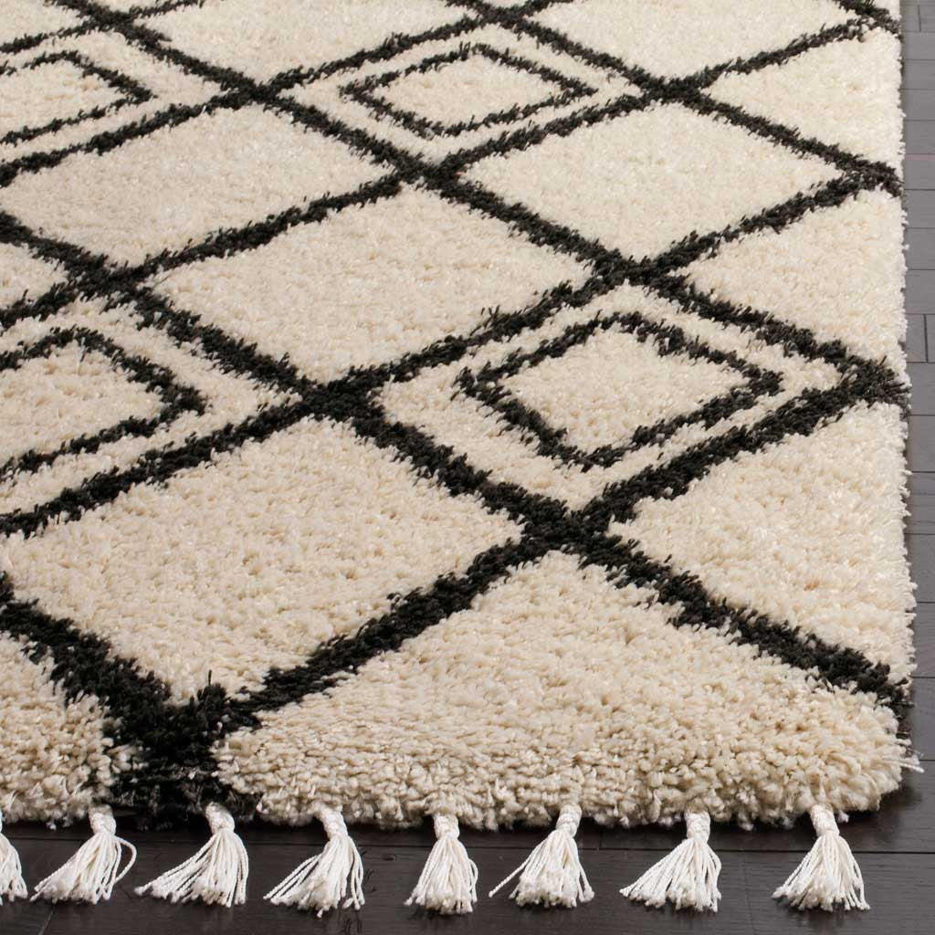 Charcoal lattice lines stand out in plush cream pile above a row of tassels