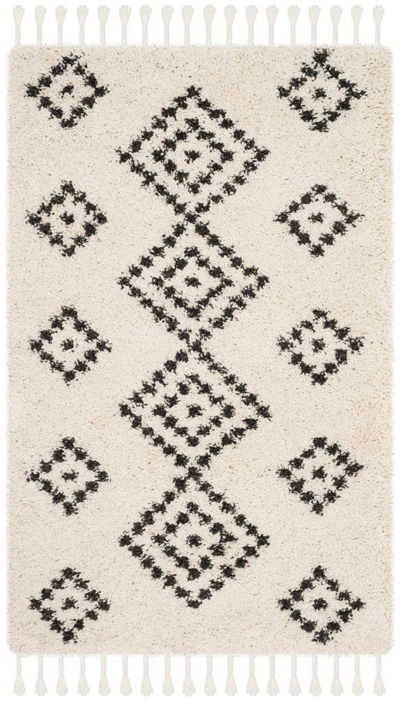 Small cream shag rug with staggered charcoal diamonds and long ivory fringe