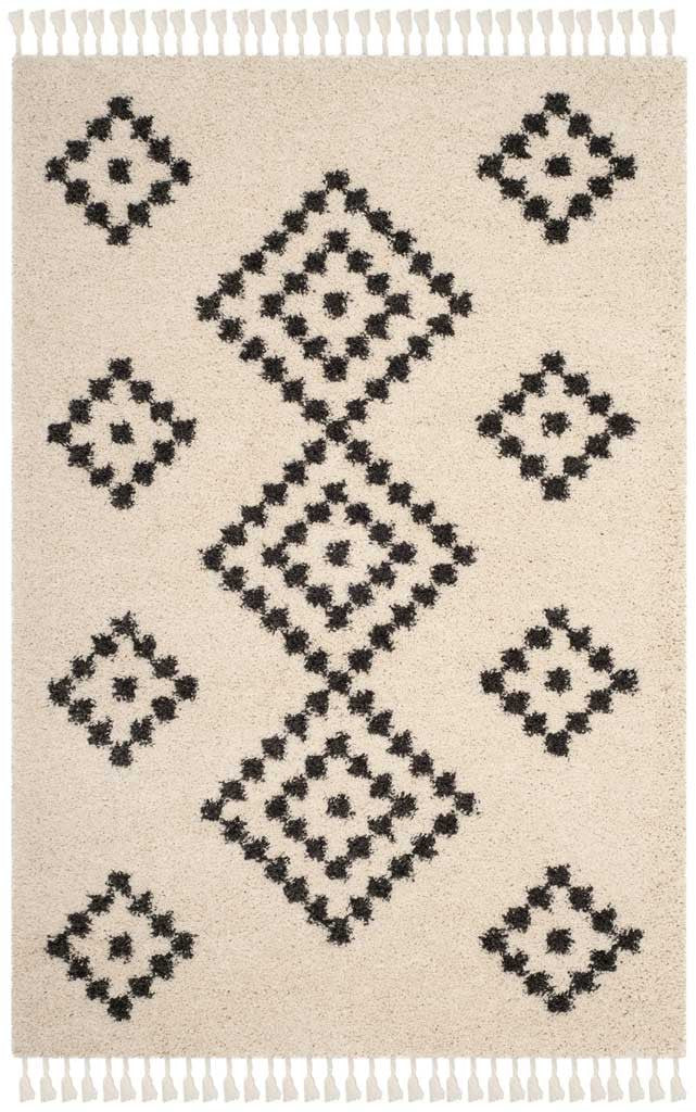 Charcoal diamond medallions punctuate a soft cream shag rug with fringe
