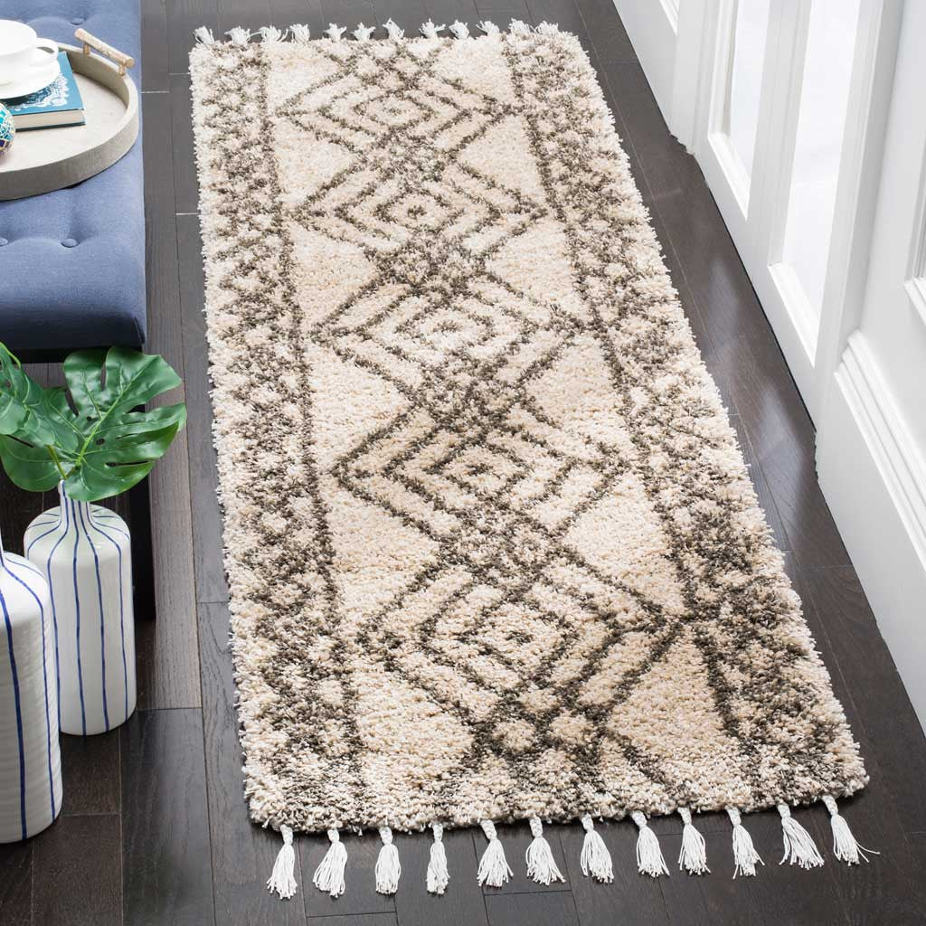 Plush mushroom and gray runner brings layered diamonds and fringed ends to a dark wood hallway