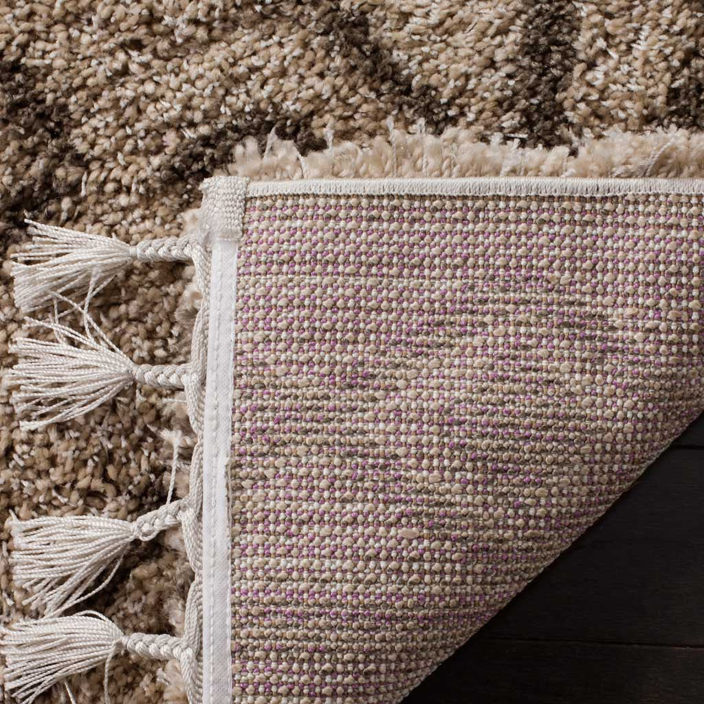 Woven backing peeks beneath plush mushroom shag and pale knotted fringe
