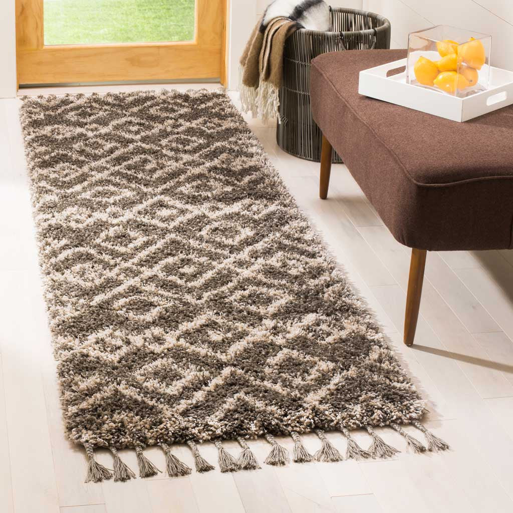Plush gray runner with cream interlocking diamonds and gray tassels grounds a bright entryway