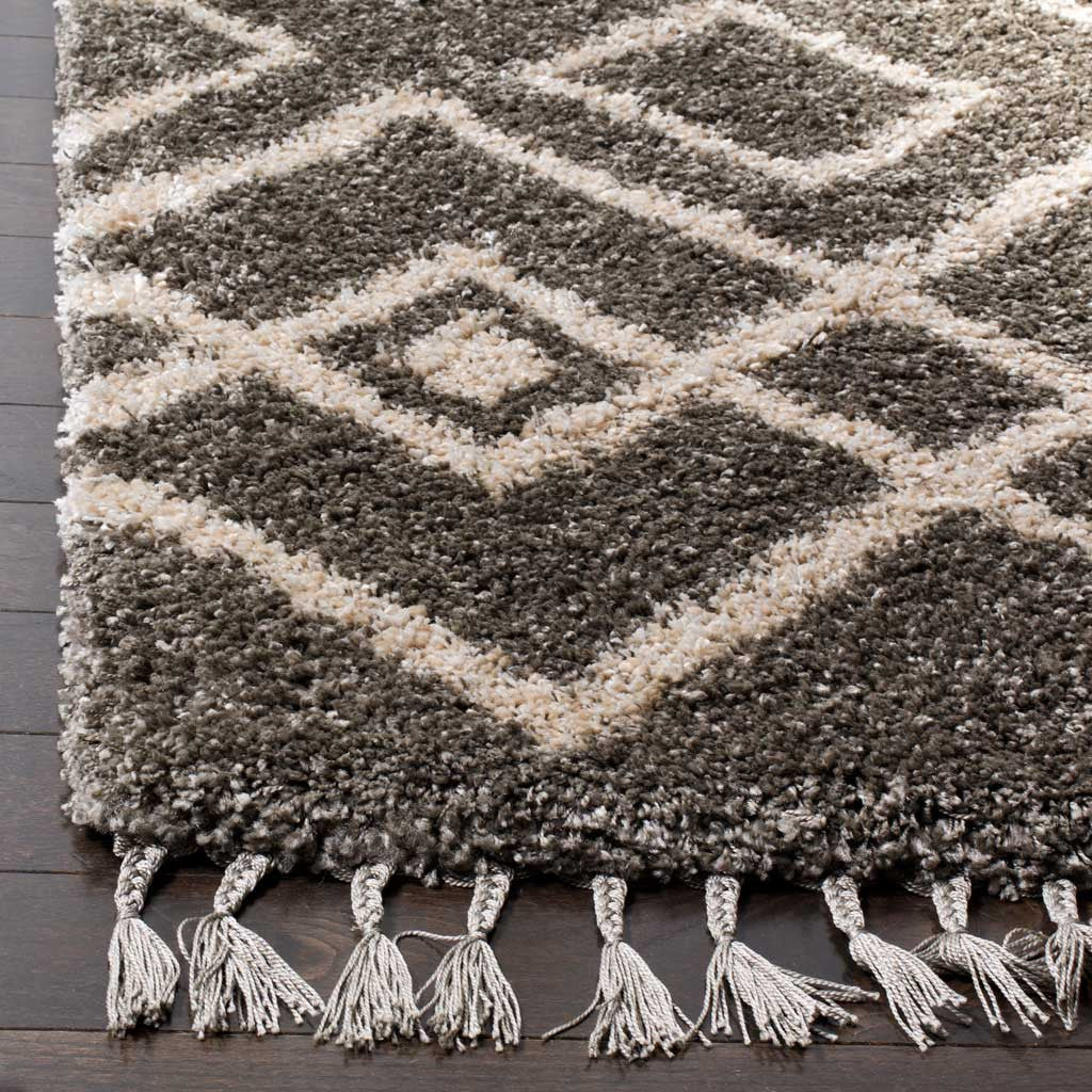 Cream diamond lines meet dense gray shag and knotted tassels at the edge