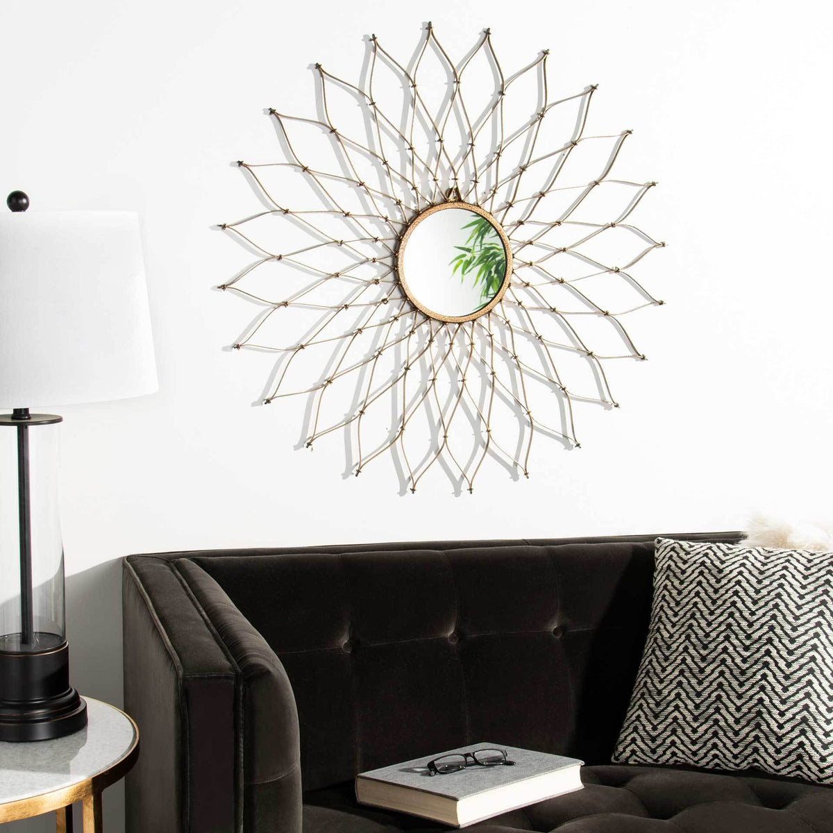 Curved gold spokes form a sculptural sunburst that brightens the wall above a sofa.