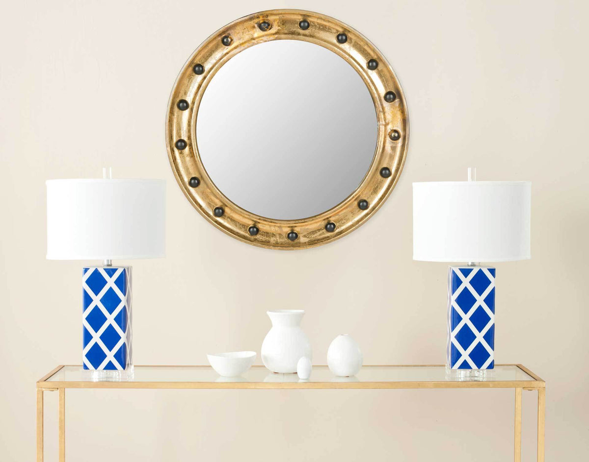 Antique gold porthole mirror brings a warm metallic focal point to the room