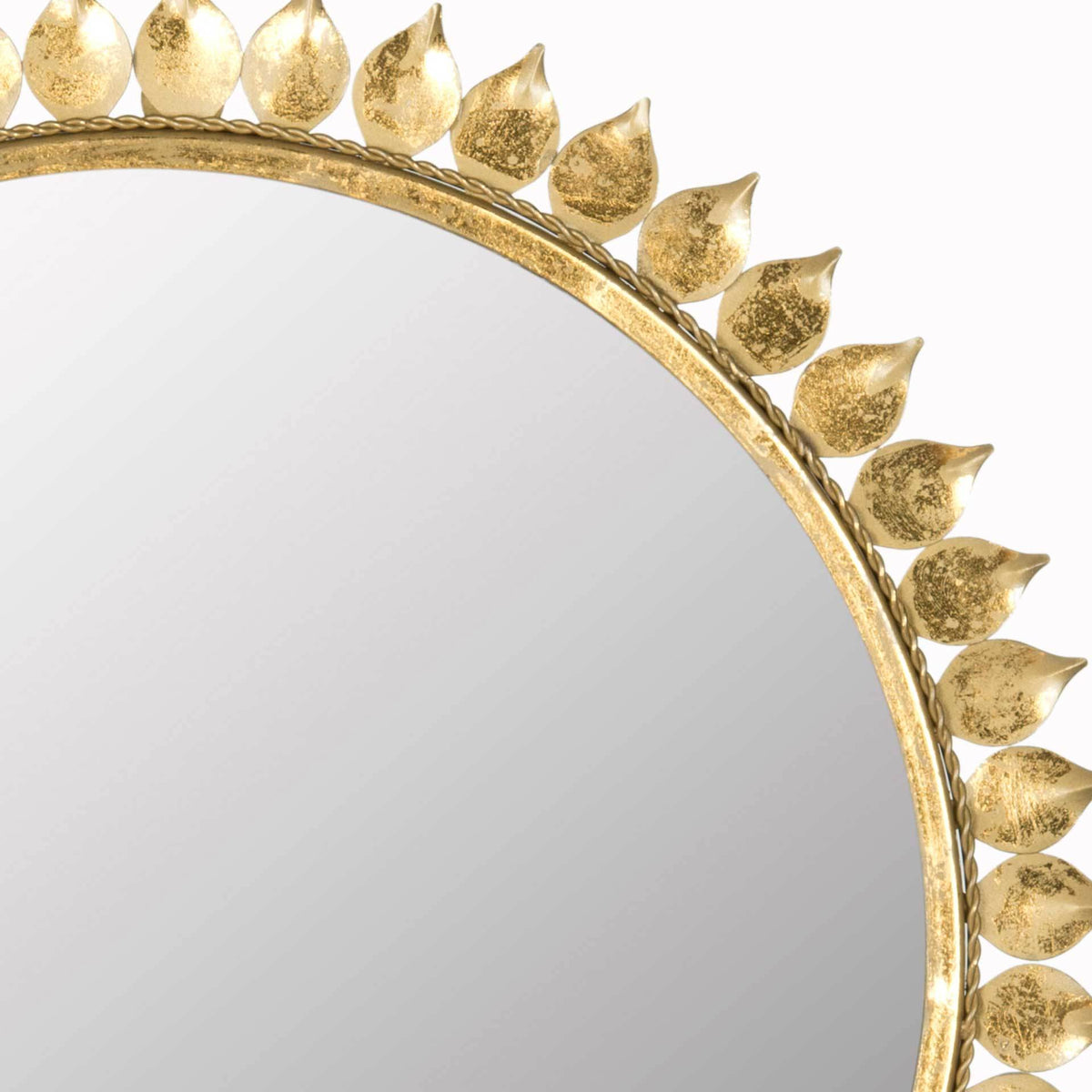 Textured gold leaves add intricate detail to the mirror's slim circular frame