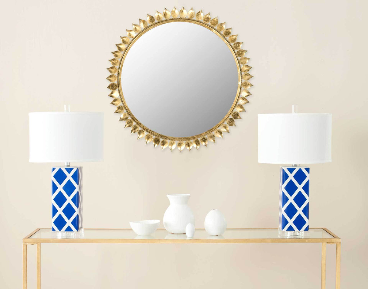 Antique gold sunburst mirror brings a sculptural accent to the wall above a console table