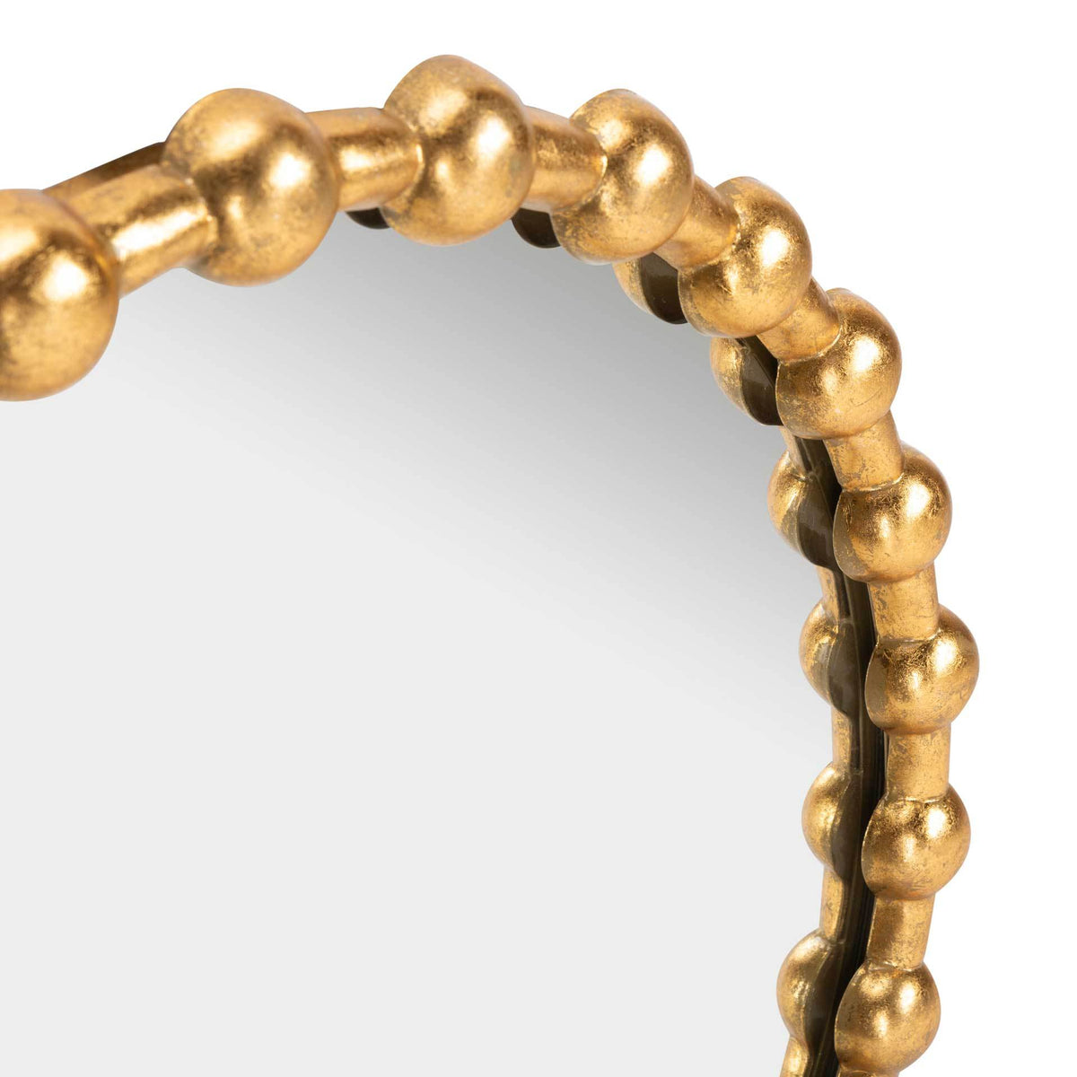 Raised gold beads give the mirror's edge a richly dimensional texture.