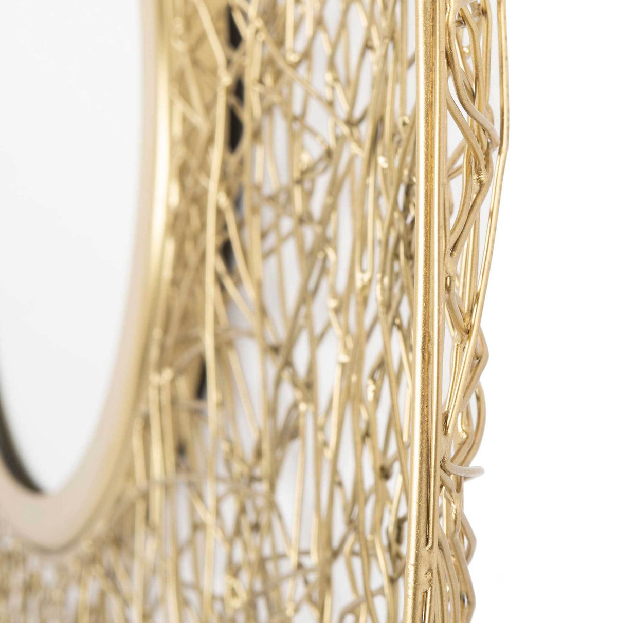Raised mirror rim and overlapping brass-colored wires give the frame sculptural depth