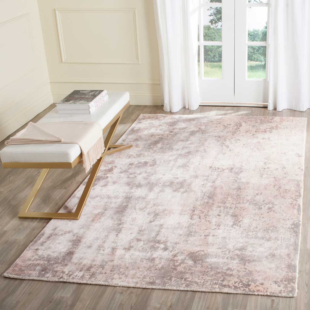 A muted wash of blush and ivory brings understated warmth to this abstract rug
