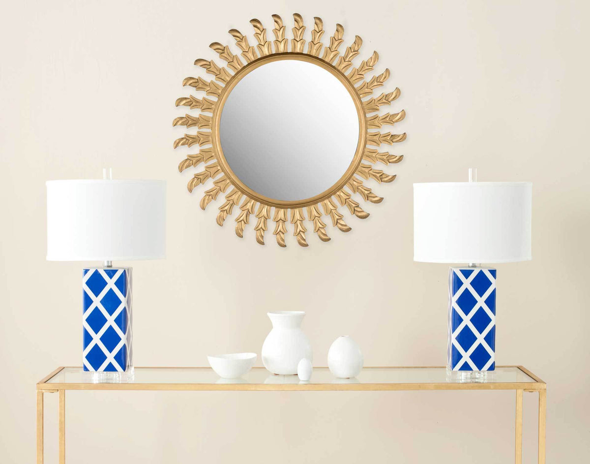 Golden leaf rays lend this round wall mirror a warm, decorative presence.