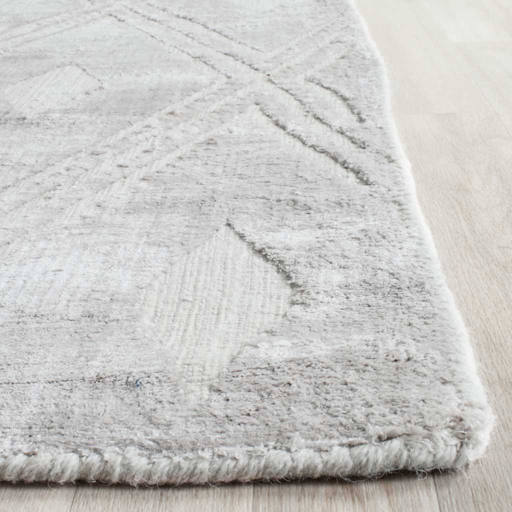 Subtle geometric lines and textured silver fibers meet a neatly finished edge