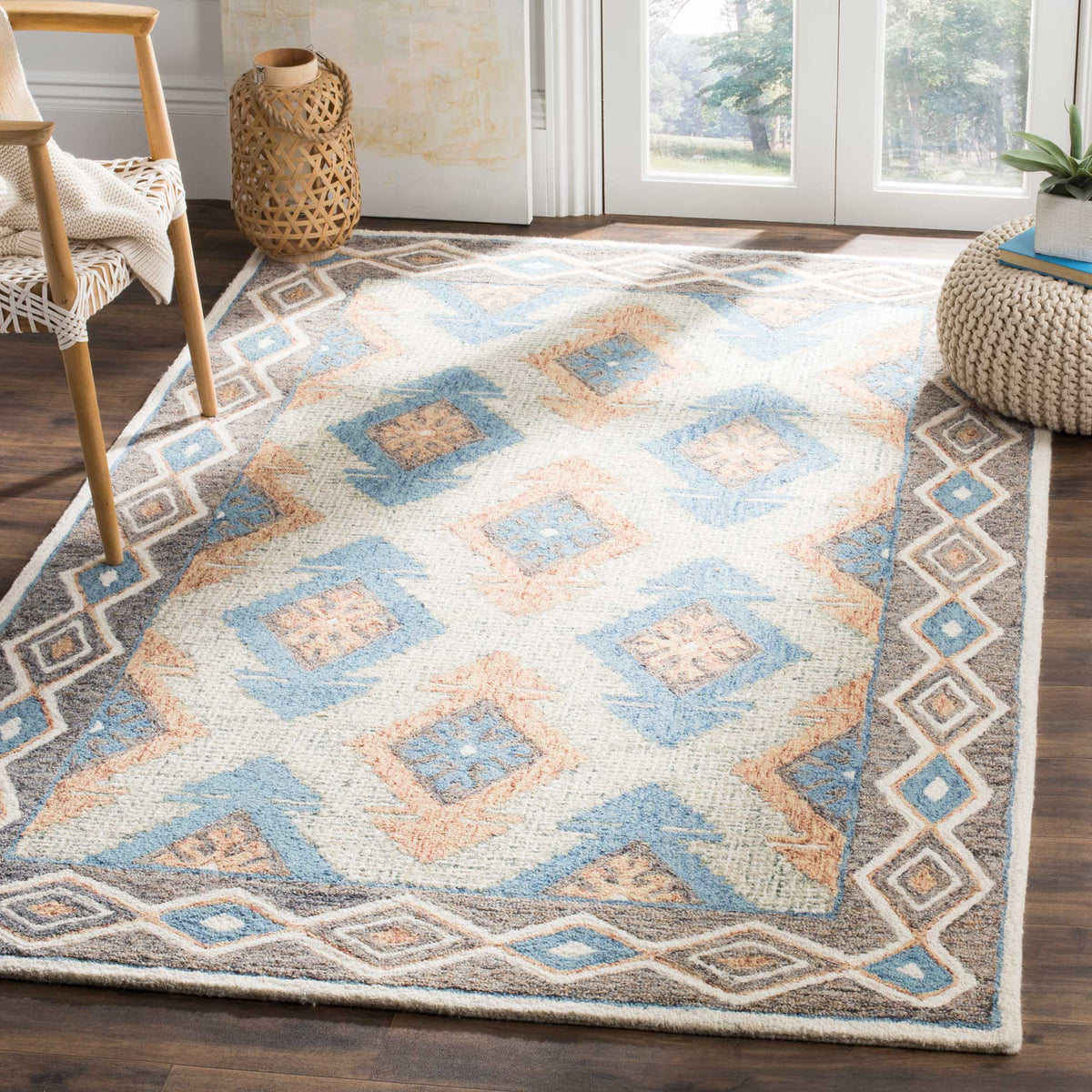 Blue and rust diamonds bring warmth to a cream wool rug with a border that defines the living space.