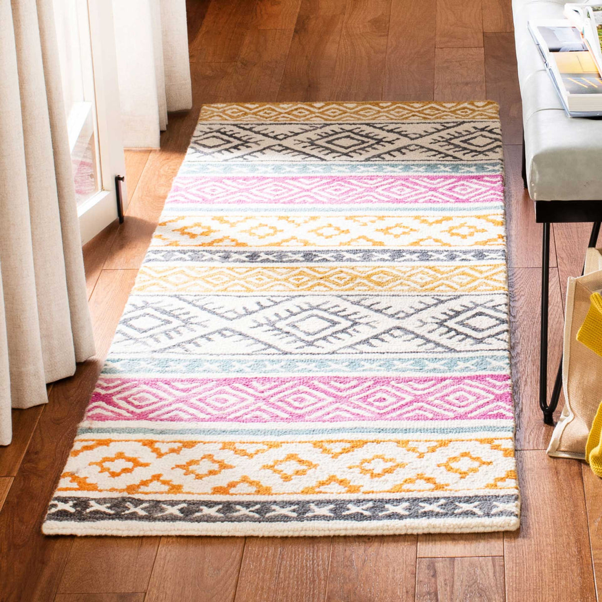 A hand-tufted runner brings colorful diamond motifs and soft texture to a warm wood floor