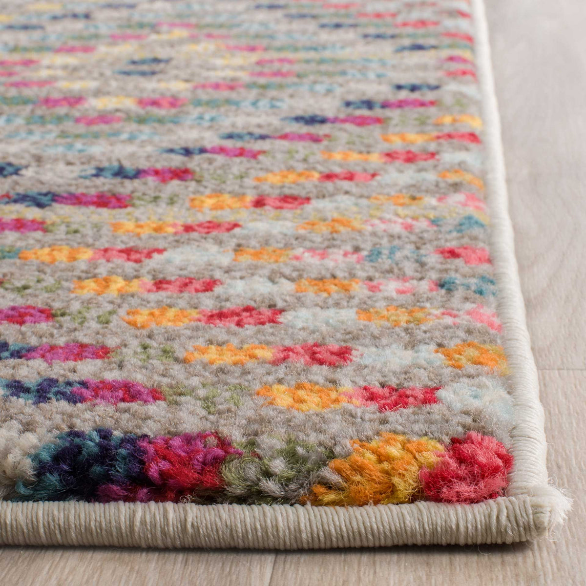 Bright, textured pile meets neatly bound ivory edges on this runner rug