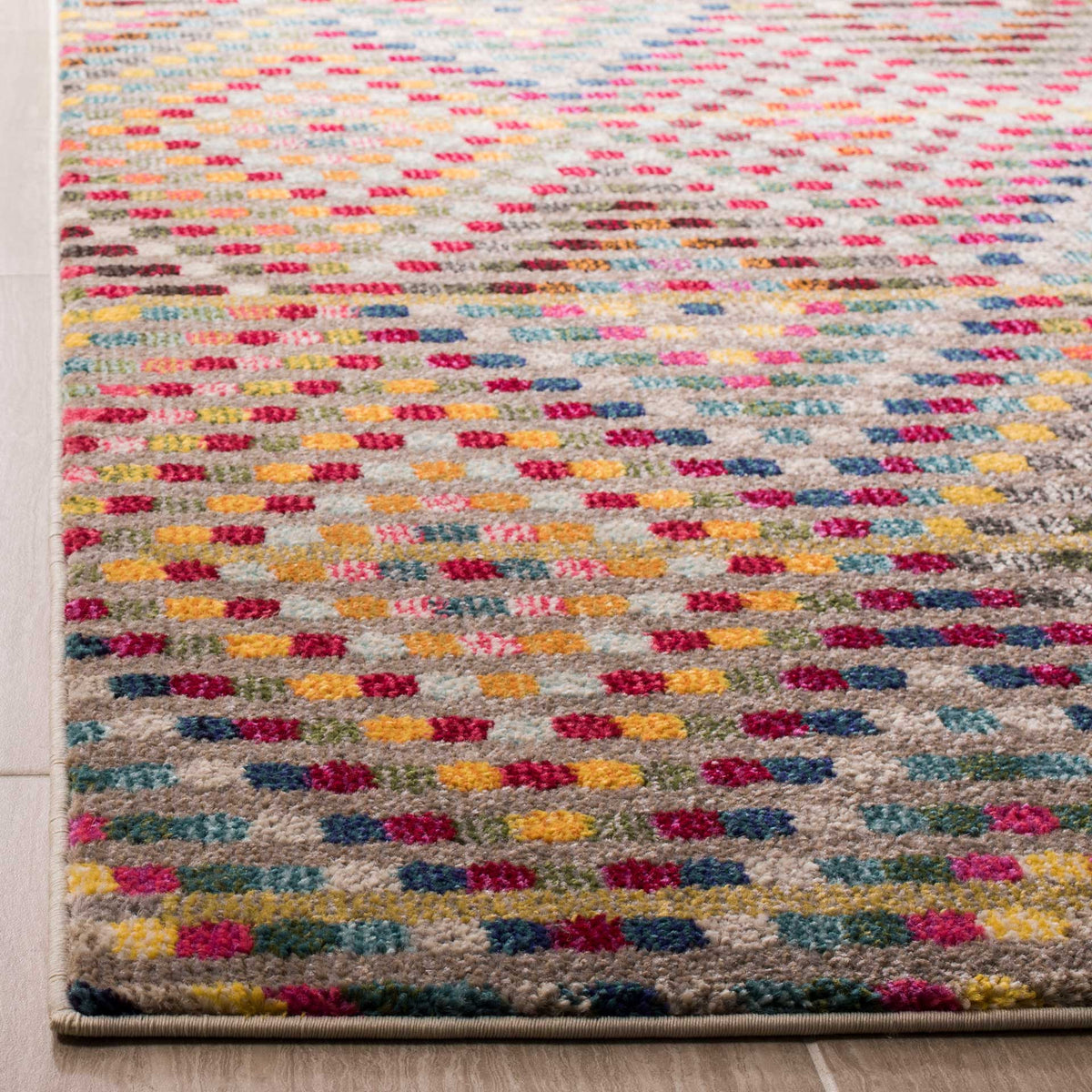 Colorful dotted pile meets a neatly finished edge on this warm beige rug.