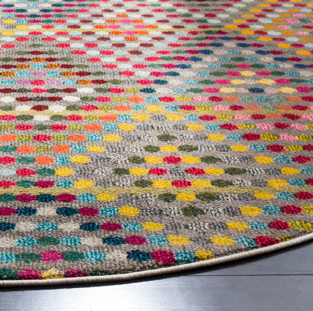 Vibrant woven dots and a neatly bound edge add playful texture to this low-pile rug