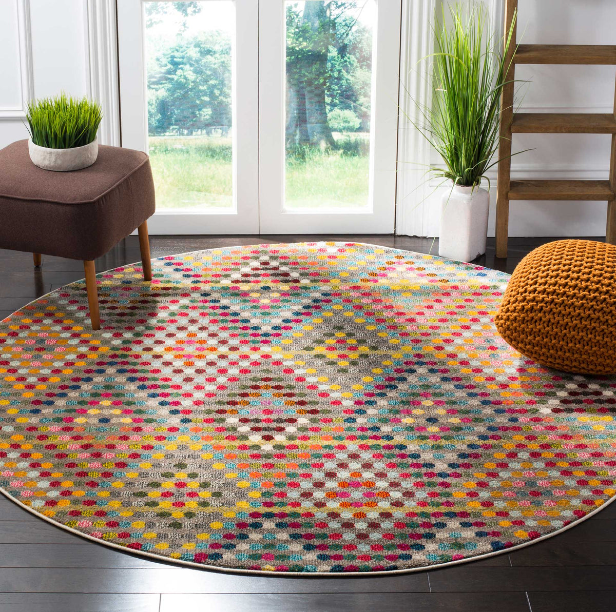 A colorful round rug anchors a living room with lively dots and a versatile beige base