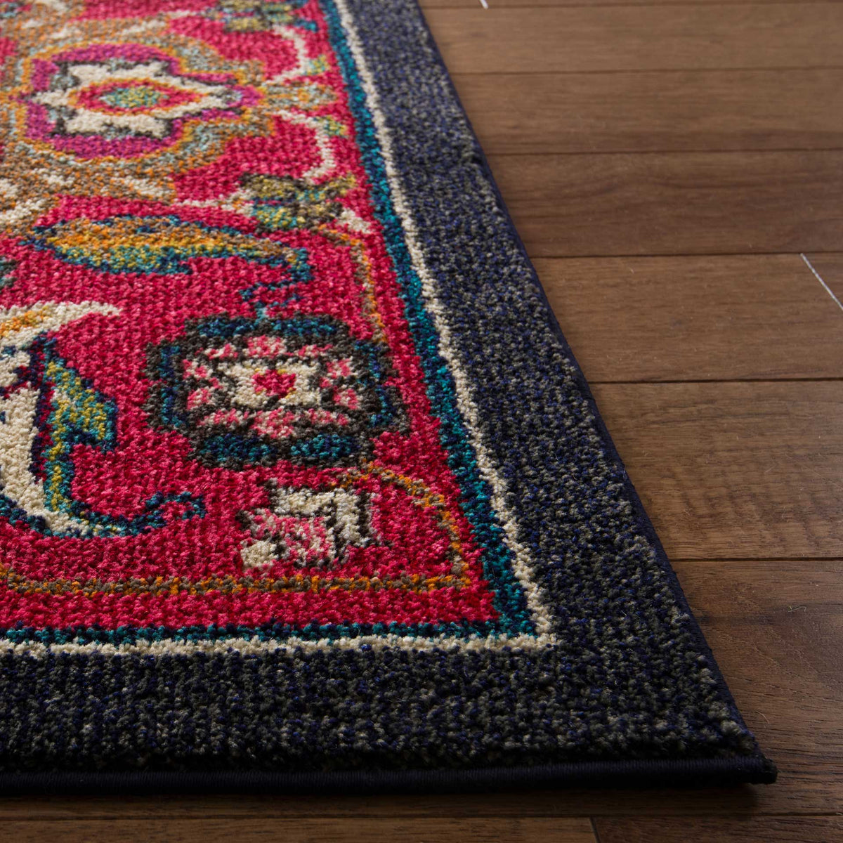 A textured navy edge frames vibrant red floral motifs with turquoise, cream, and gold accents.
