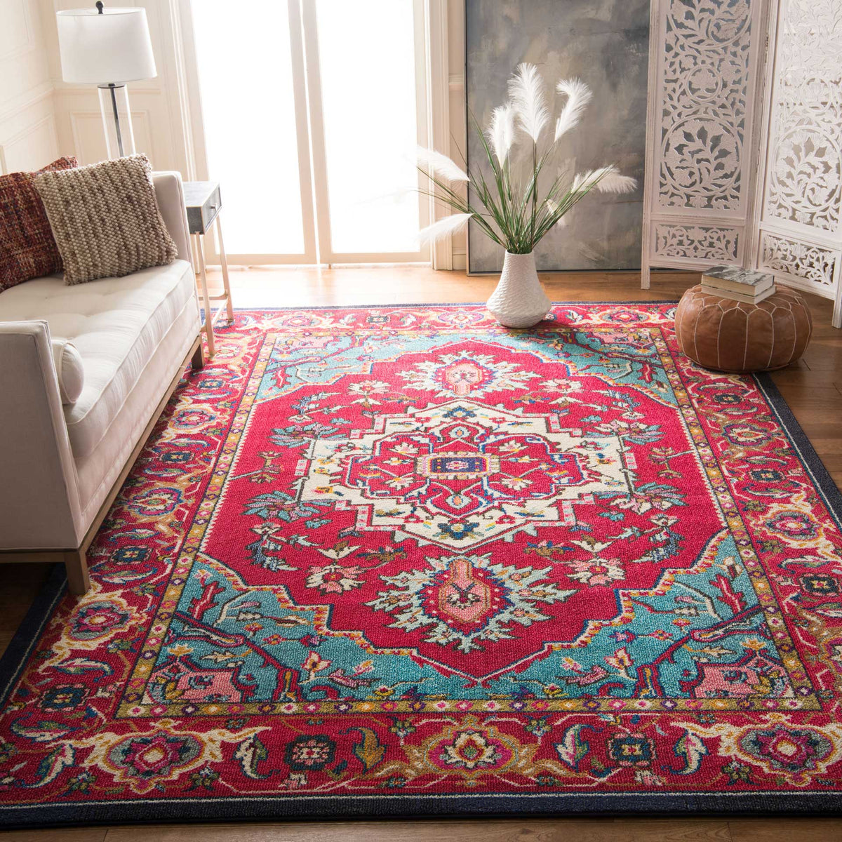 Bold red florals and turquoise corner details frame a cream medallion on this patterned area rug.