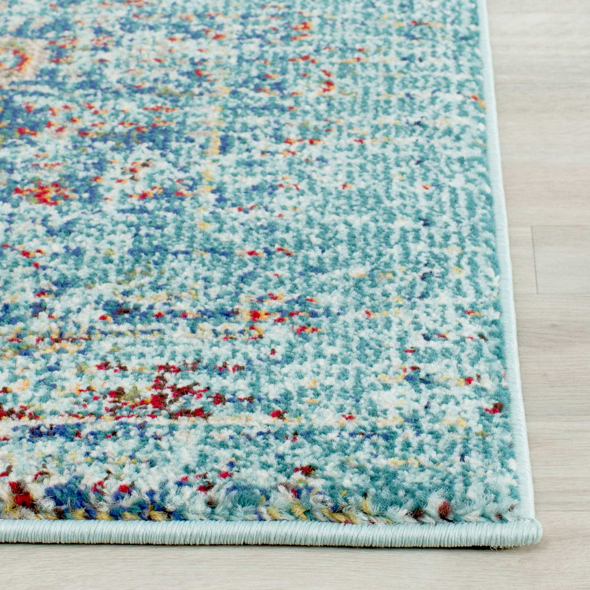Pale blue binding frames textured aqua pile flecked with navy and coral