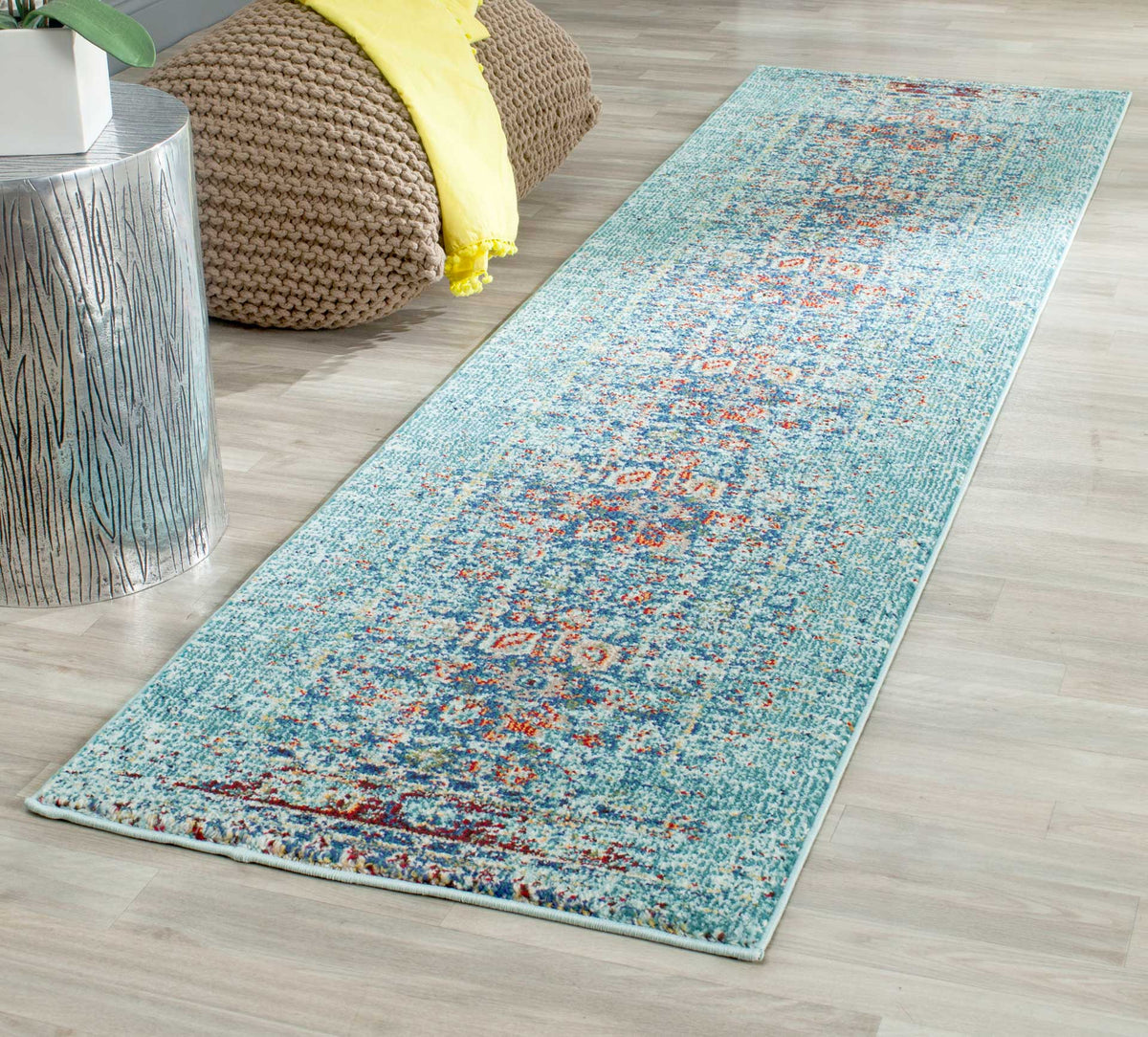 A slender blue runner adds timeworn oriental pattern and vibrant accents to a light wood floor