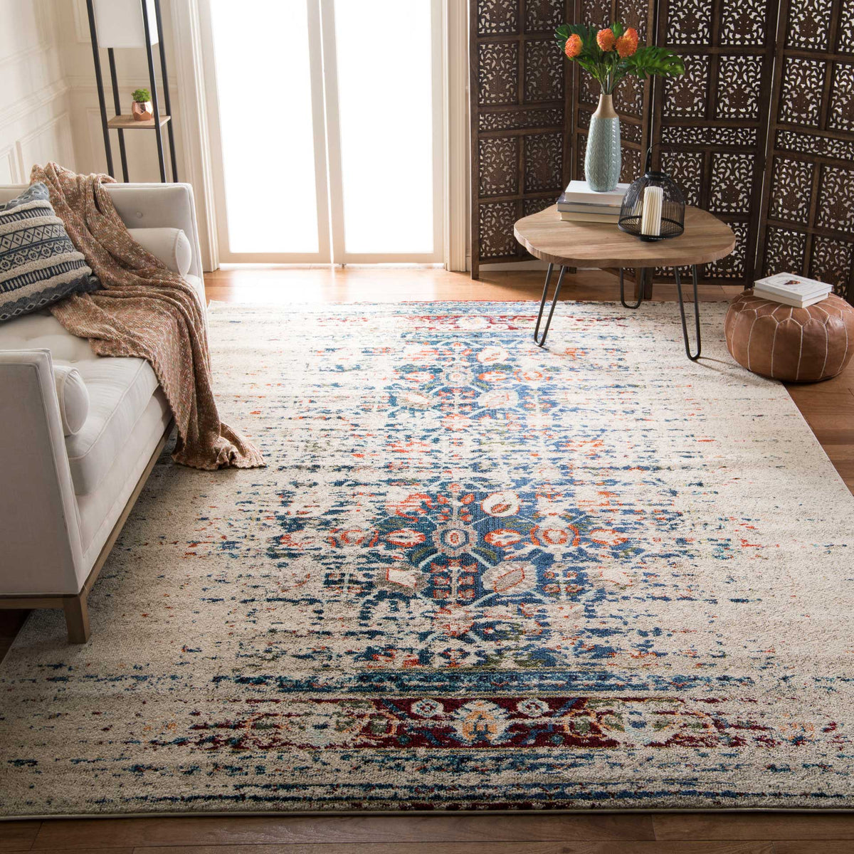 Ivory and blue floral rug anchors a living room with a coral-accented center