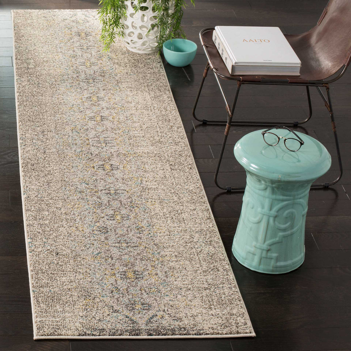 Subtle gray and blue motifs give this slender runner vintage character against dark wood floors.