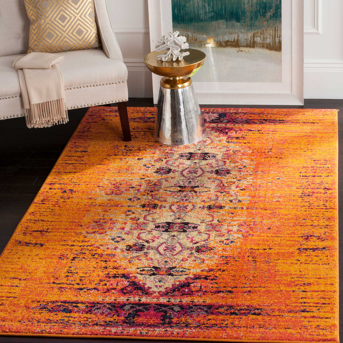 A vivid orange medallion rug adds a bold patterned layer beneath a neutral armchair