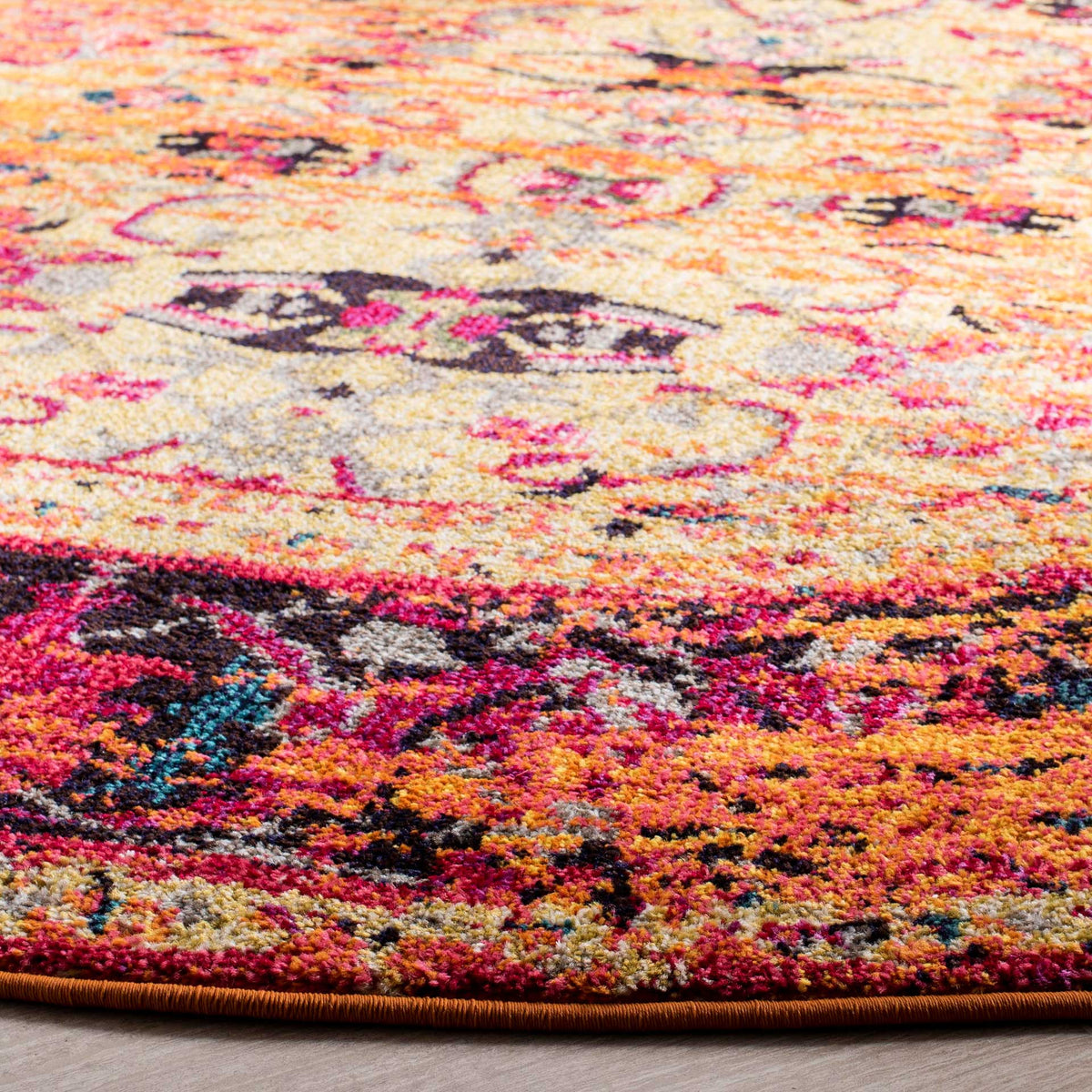 Orange pile surrounds pink and navy floral motifs, finished with a slim bound edge.
