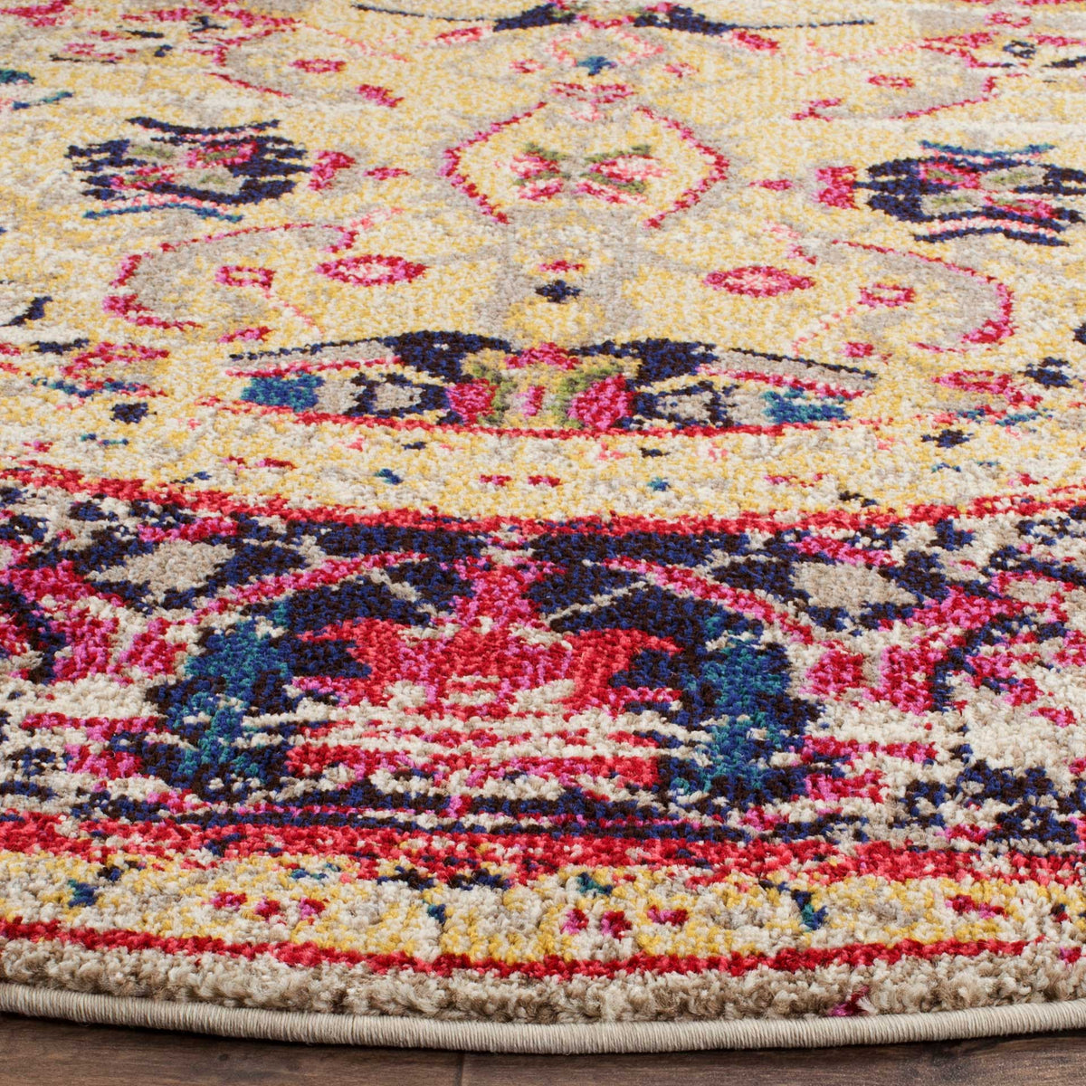 Vivid pink and navy floral motifs contrast with the ivory pile and neatly bound edge.