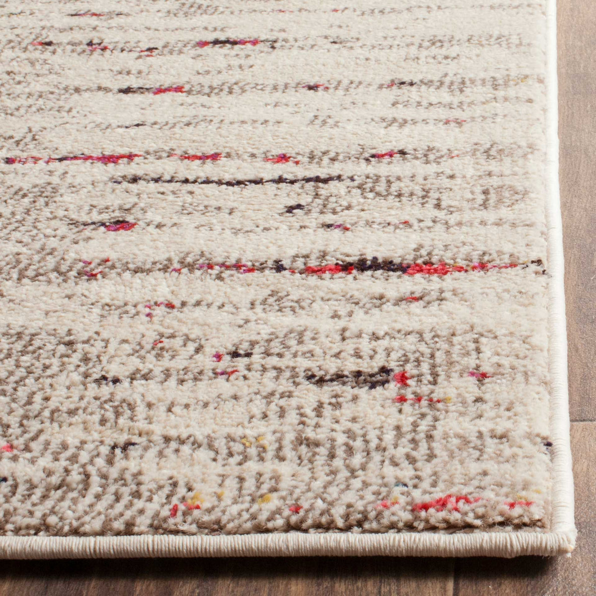 Soft ivory pile with scattered pink and navy strokes meets a neatly bound corner