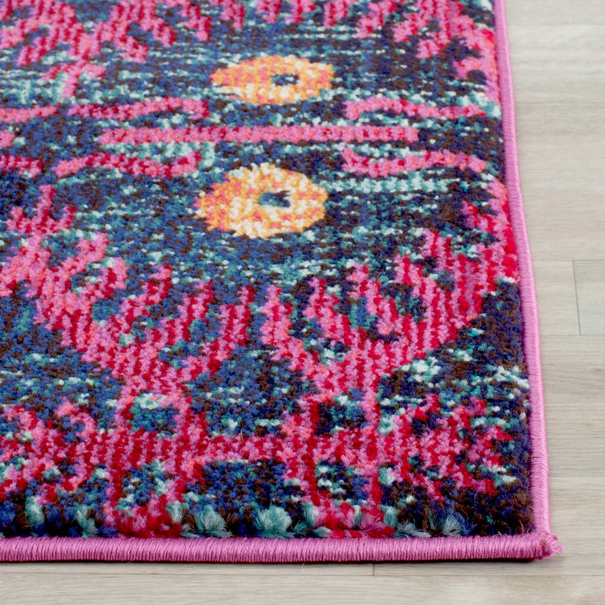 Pink binding frames textured blue and magenta pile with touches of golden yellow
