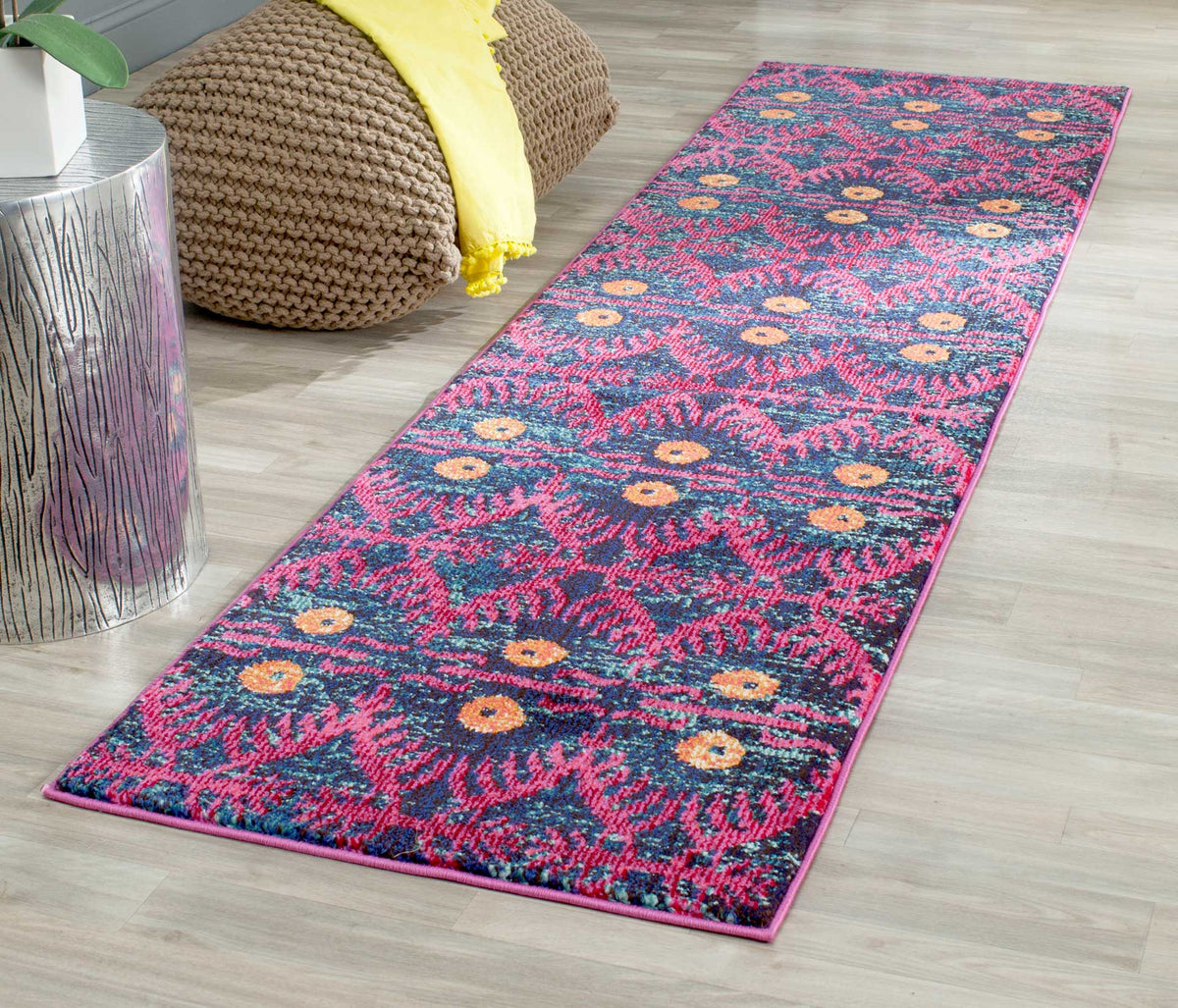 Colorful runner rug brings bold pink and blue motifs to a narrow living space