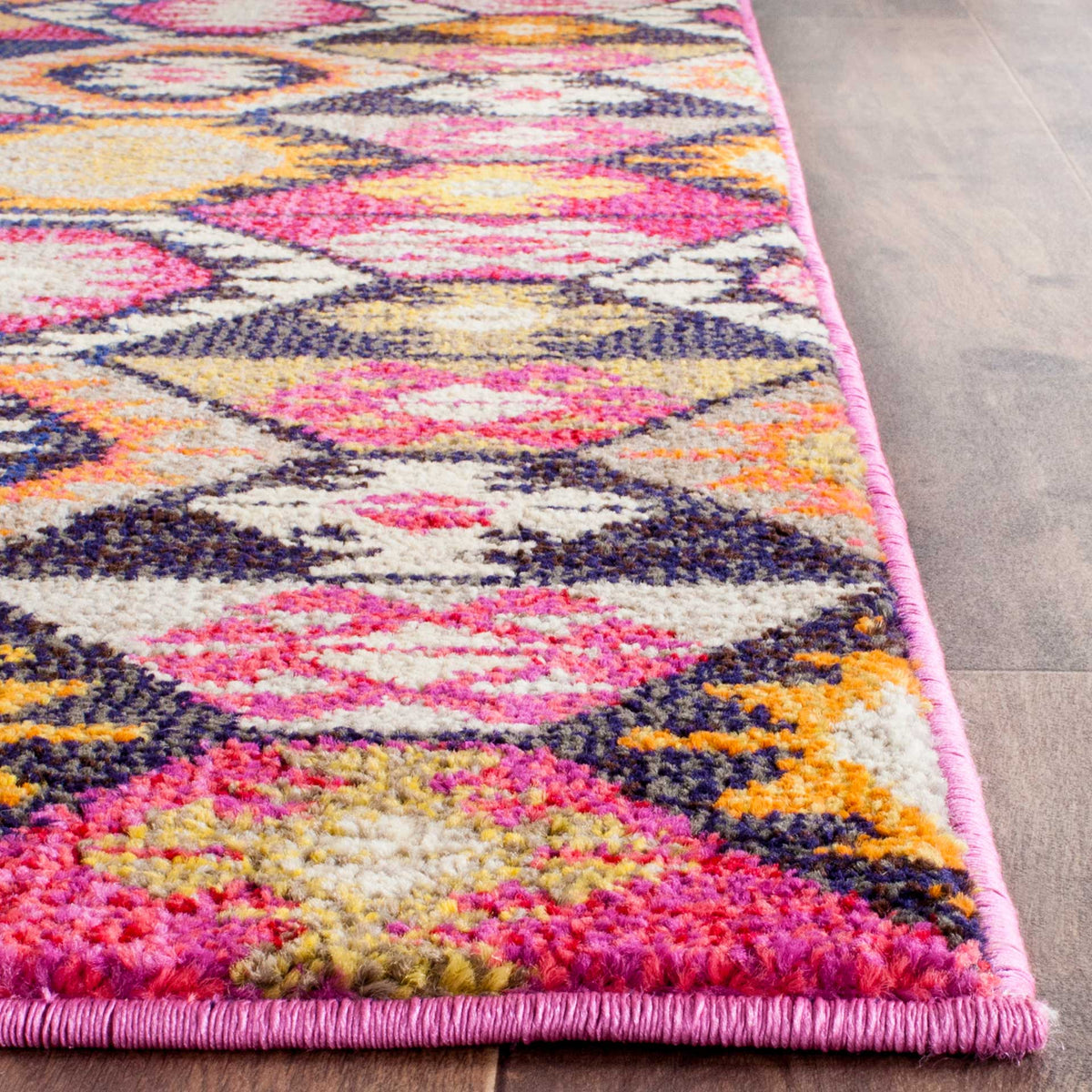 A dense, colorful pile and crisp pink binding give this geometric rug a lively finish.