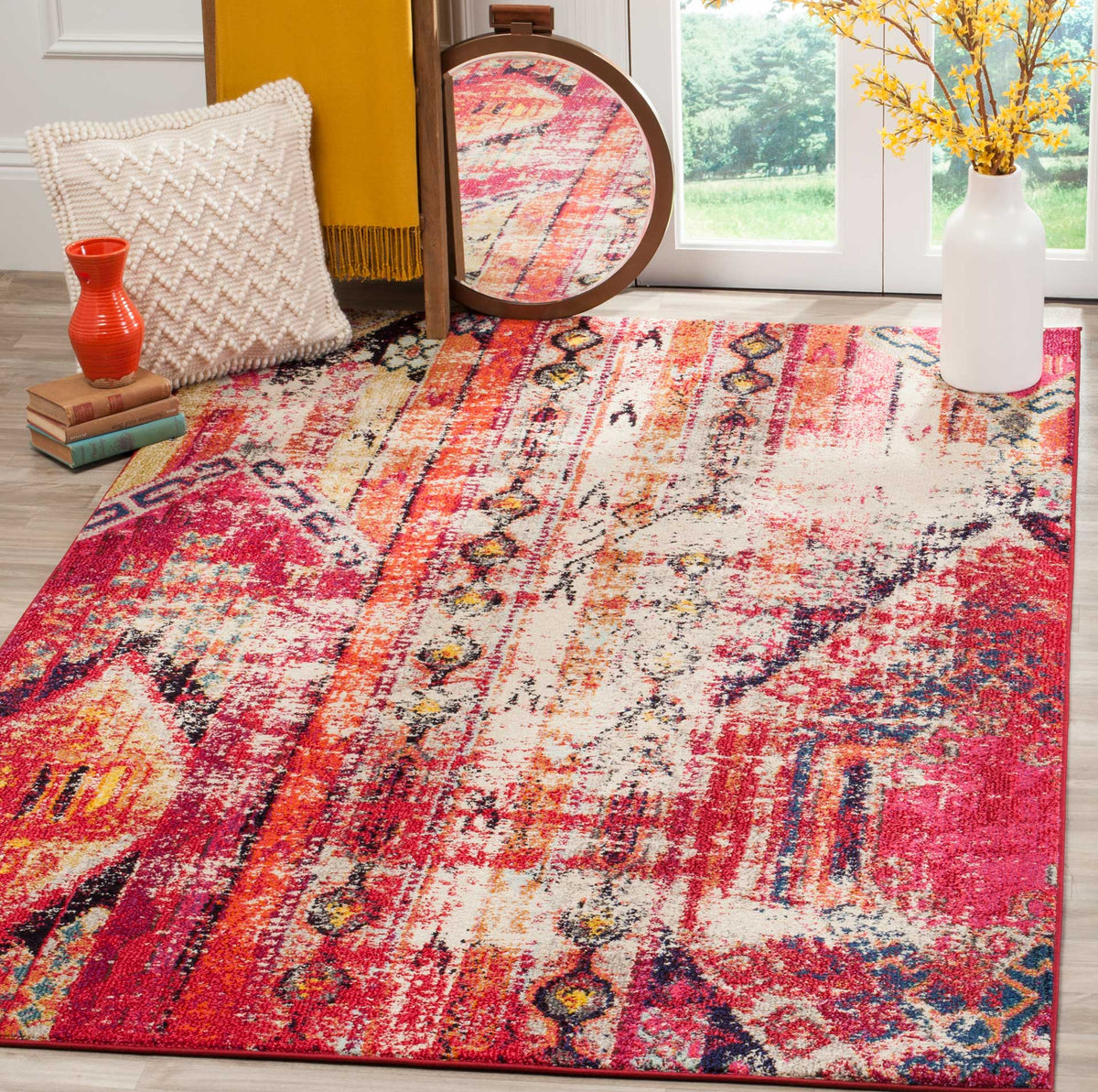 Magenta and cream rug adds bold color with layered stripes and distressed diamond motifs