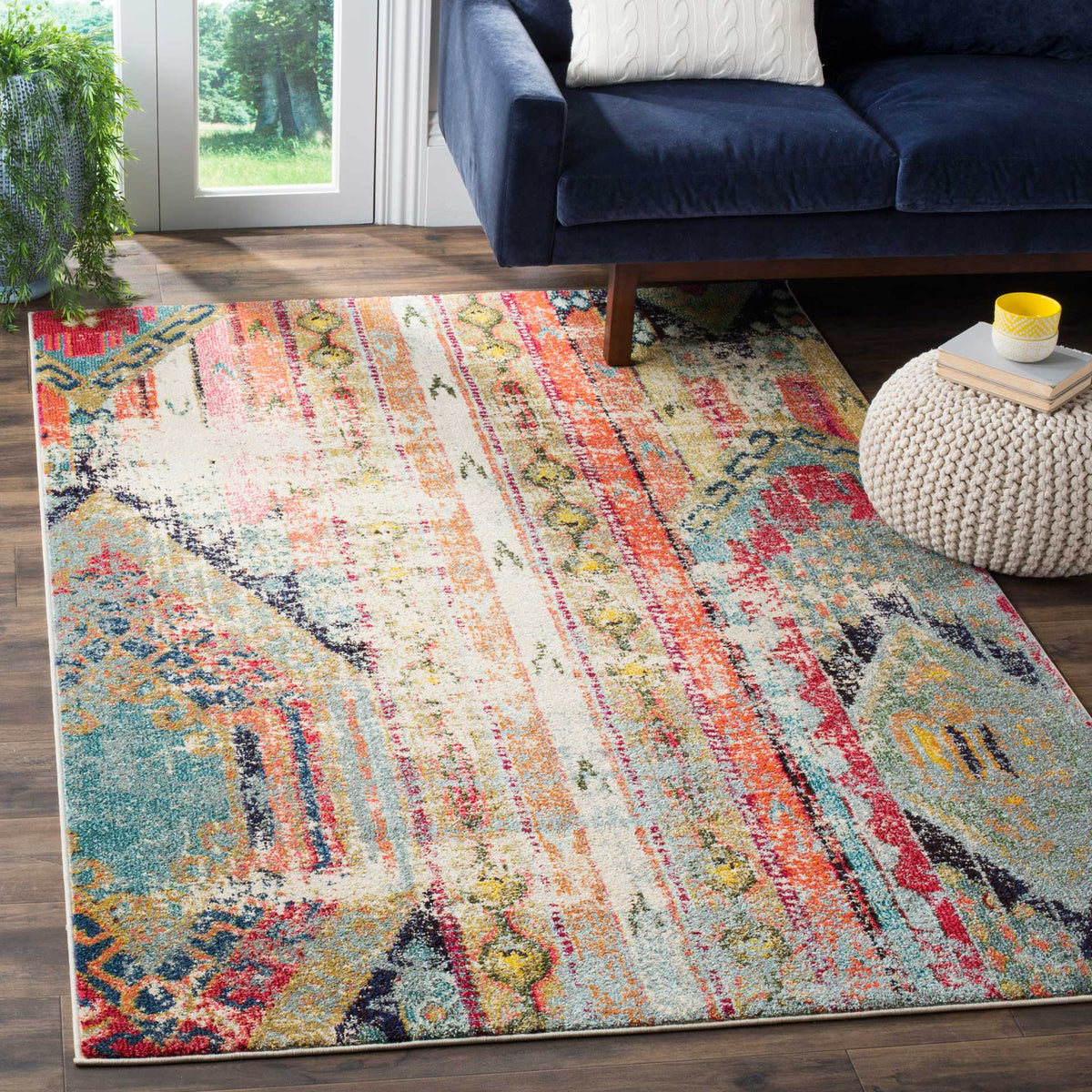 Bright teal, coral, and cream geometric motifs add playful color beneath the seating area