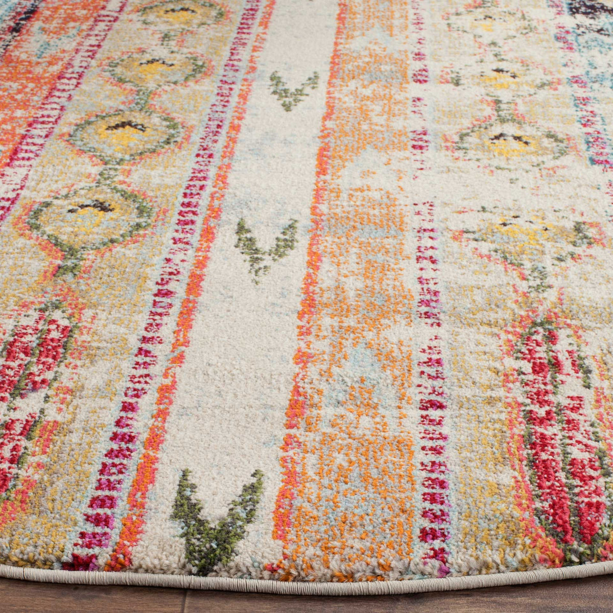 Coral and pink stripes cross soft blue and ivory pile above a neatly bound edge