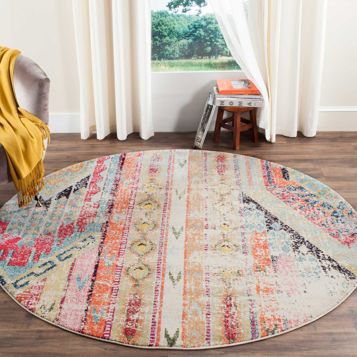 A multicolored round rug adds lively stripes and softly distressed motifs to a living space