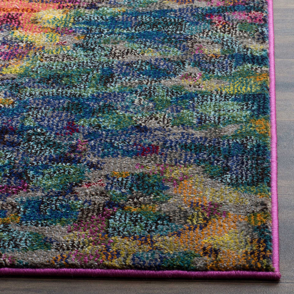 Fuchsia binding finishes textured pile in deep blue, teal, orange, and gold