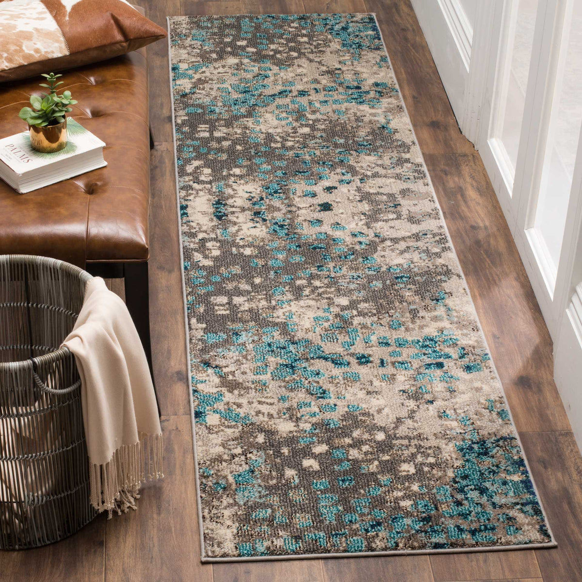 Light blue flecks enliven the weathered gray pattern of this narrow runner rug