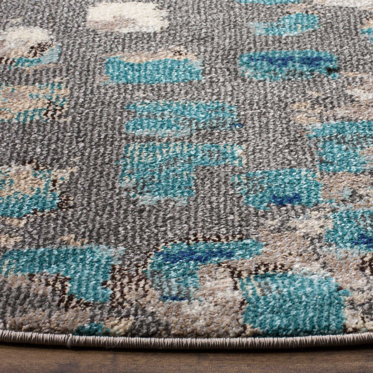 Textured blue accents enliven mottled gray pile, with a neatly bound edge