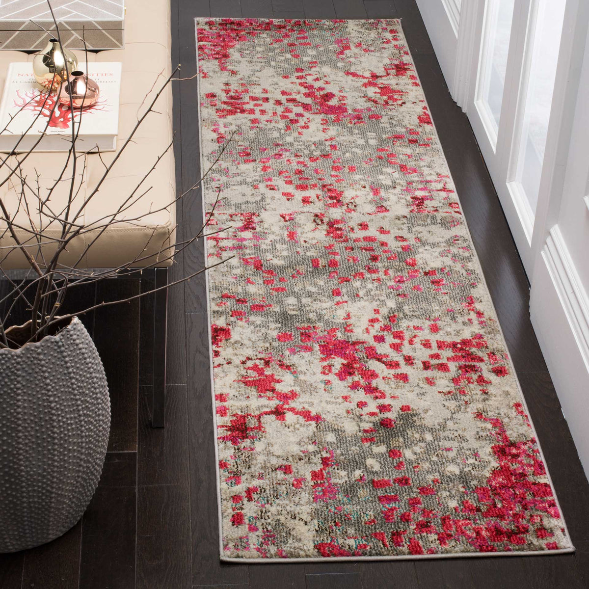 Fuchsia accents brighten the weathered gray design of this contemporary runner rug