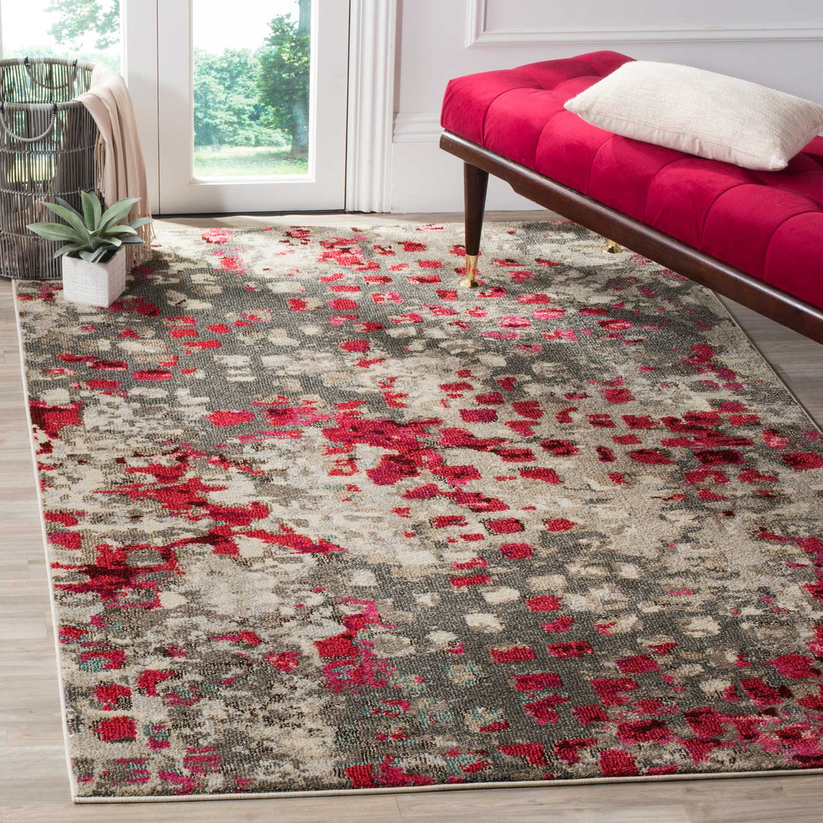 Gray and fuchsia abstract rug makes a lively foundation beneath a tufted magenta bench