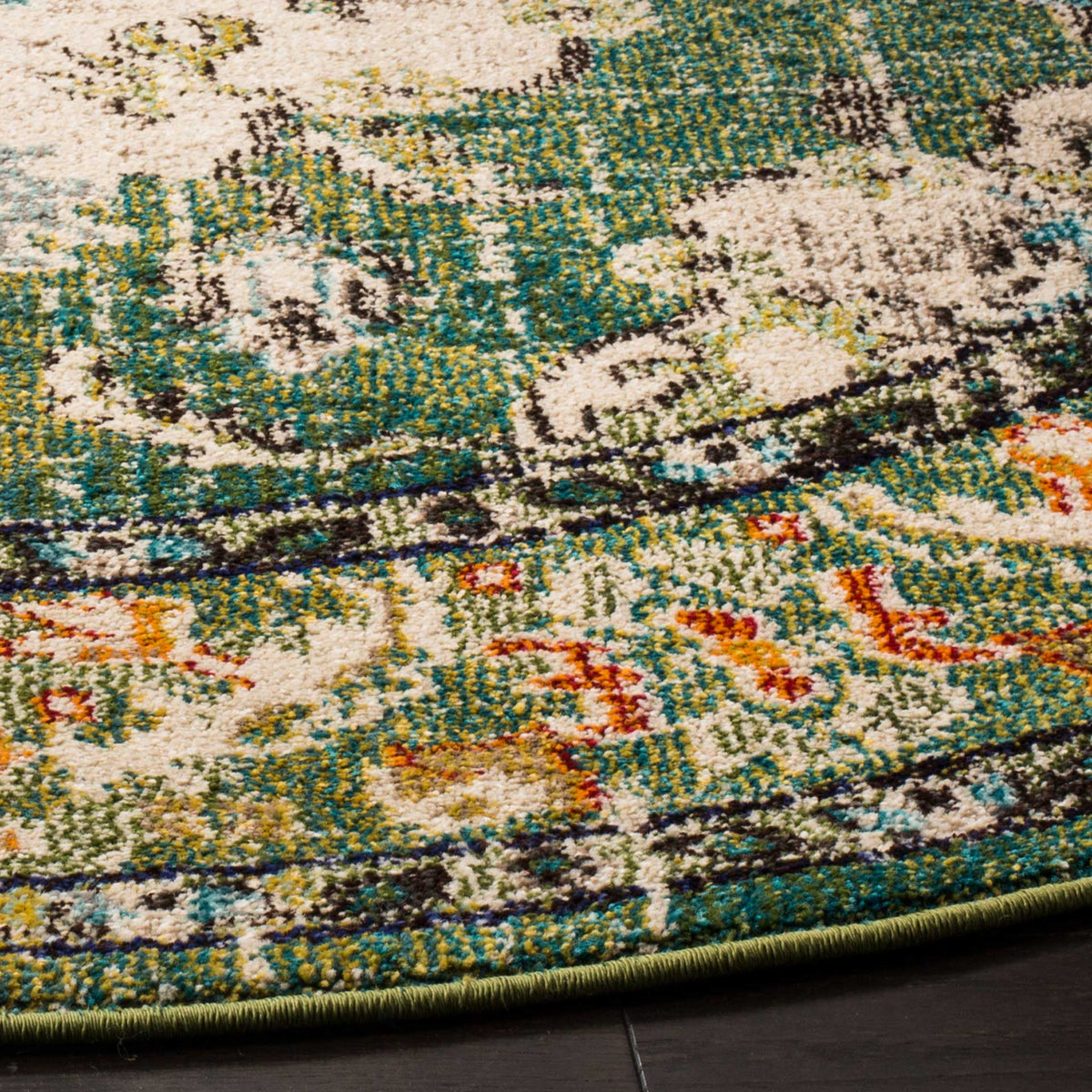 Forest green and cream floral motifs meet a multicolored border above a neatly bound edge