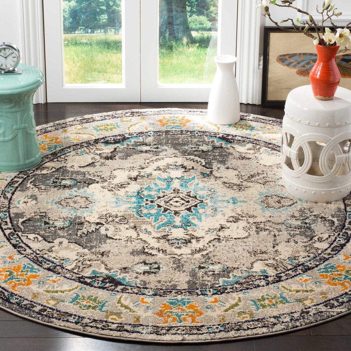 Cream and gray medallion detailing gives this round rug a classic look with pops of blue and orange