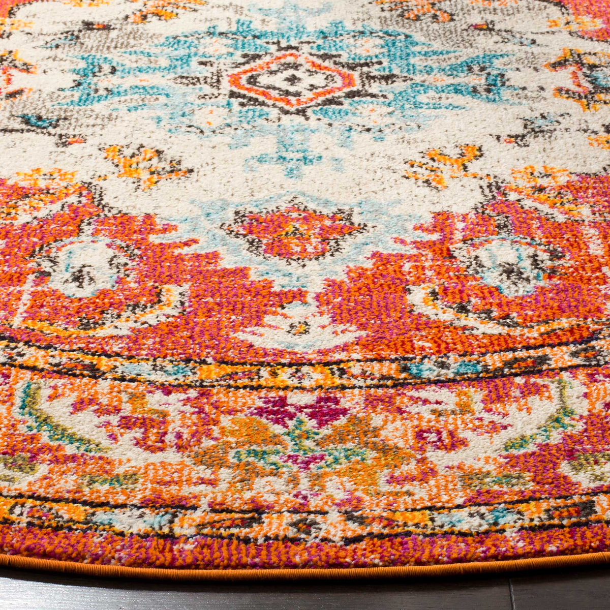 Dense orange and pink motifs contrast with pale blue scrolls above a neatly bound orange edge