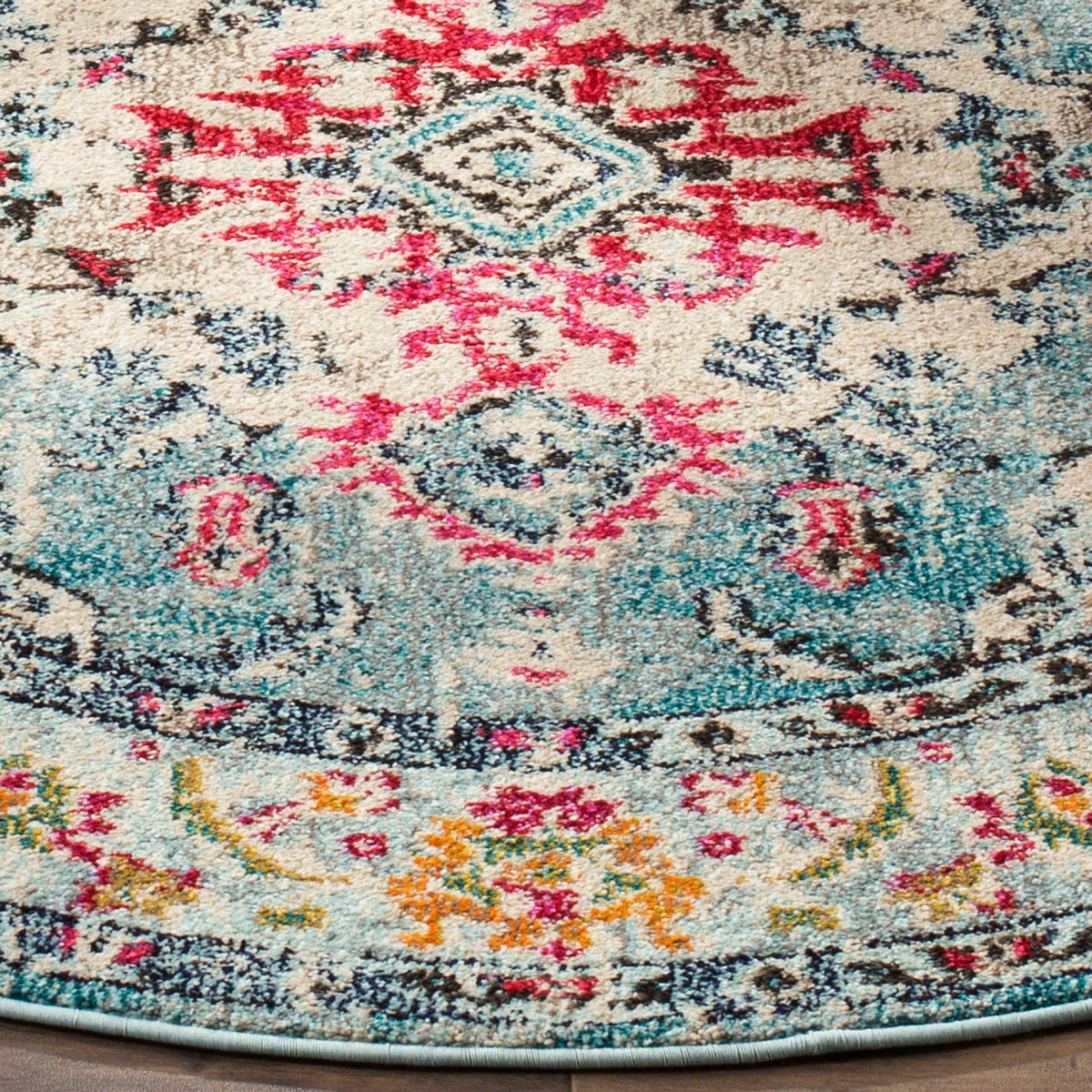 Fuchsia motifs mingle with light blue and warm orange florals above the neatly finished edge